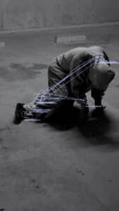 Data analysis of a person kneeling on the ground with overlaid digital information and graphical elements.