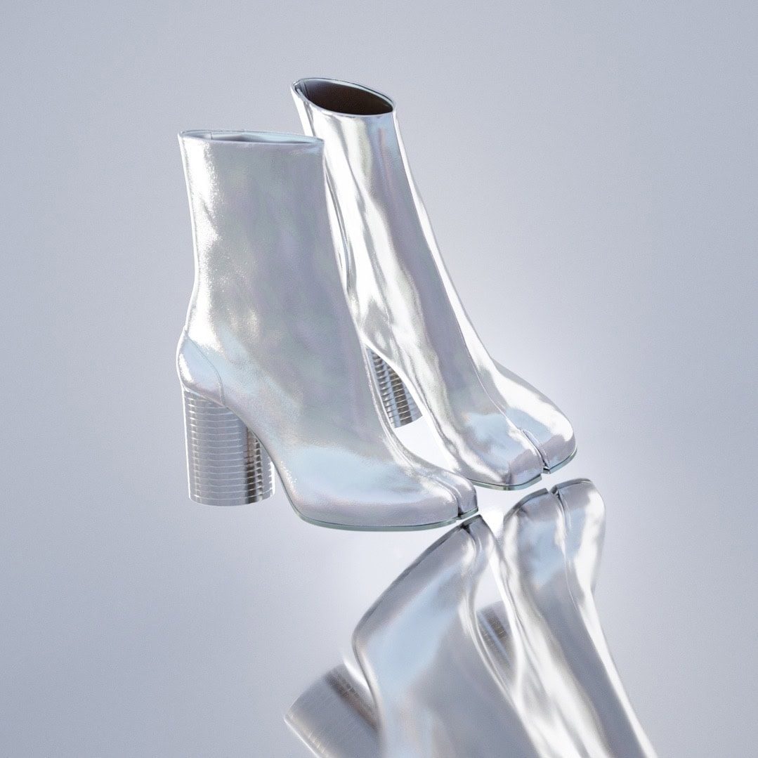 Shiny metallic high-heel boots with block heels, reflective surface, modern fashion footwear.