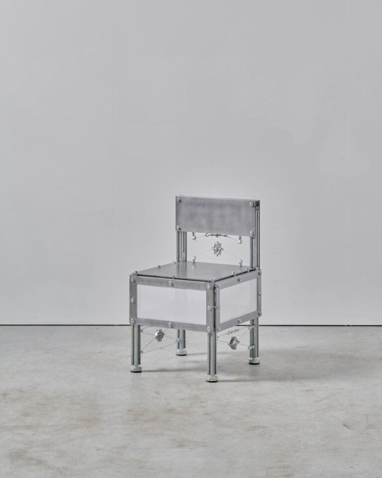 Sigurd Nis Schelde's innovative objects navigating the intersection of art and functionality Metal chair sculpture with industrial design, minimalist aesthetic, and sleek aluminum finish.