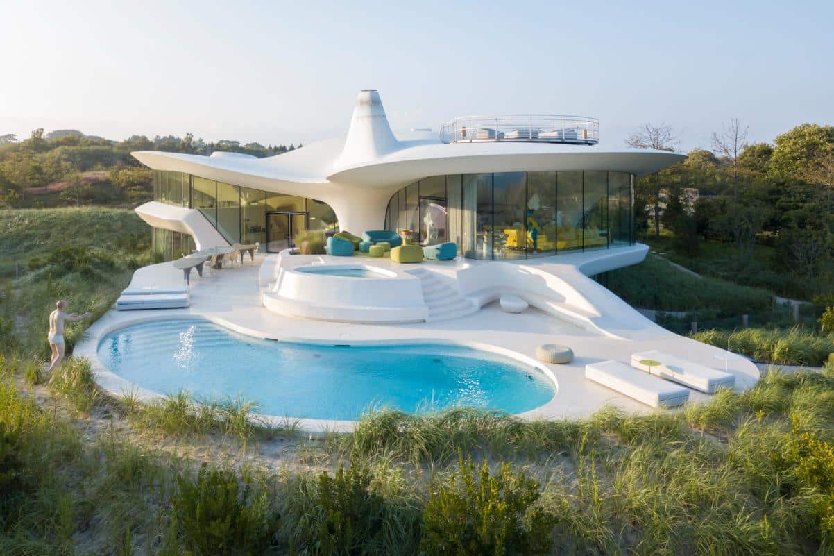 Modern futuristic house with unique architecture and swimming pool amidst nature.