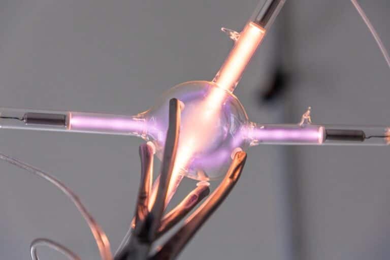 Artist Emilija Povilanskaitė captures the stellar process of helium fusion in "Helium Burning" High-tech plasma ball with glowing electric arcs and colorful lights for science experiments and modern decor.