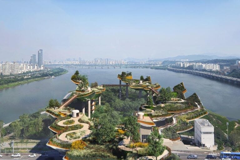 Heatherwick Studio to transform Seoul’s Nodeul Island into a cultural oasis Aerial view of a modern eco-park with green terraces and city skyline in the background.