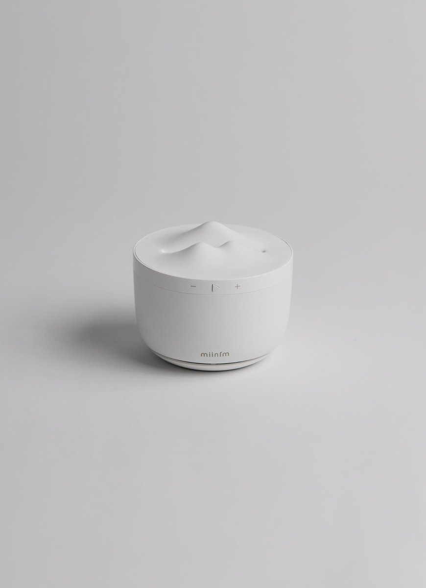 Sleek white ultrasonic essential oil diffuser on light gray background.