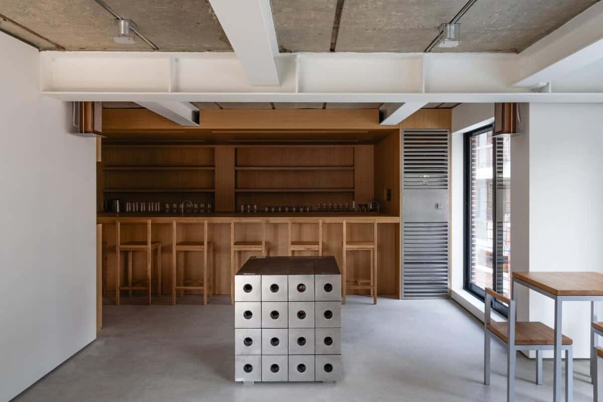 Modern minimalist bar with wooden accents and industrial concrete elements at Visual Atelier 8.