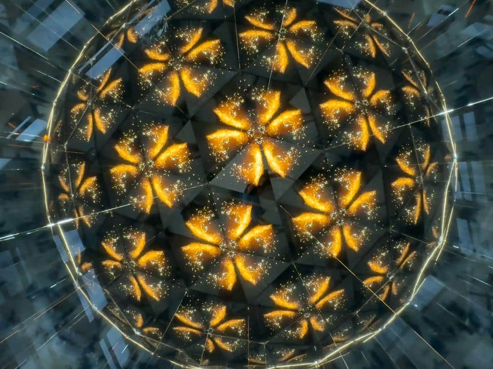 Vibrant golden butterfly-shaped light display with sparkling accents, creating a mesmerizing visual effect.