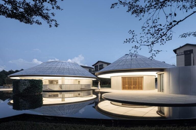 Futuristic modern pavilions with circular roofs by water at dusk, contemporary architecture, elegant design.