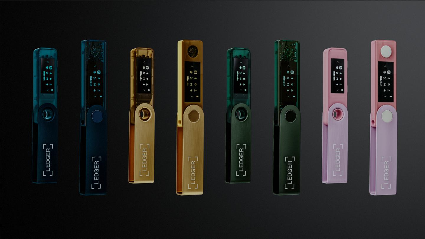 Colorful digital portable electronic devices in rainbow shades on a dark background.