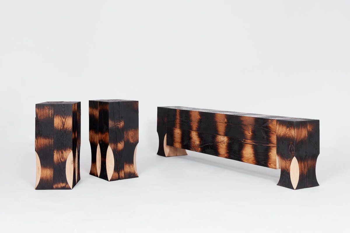 Burnt wood furniture set with modern rustic design and distinctive charred finish.