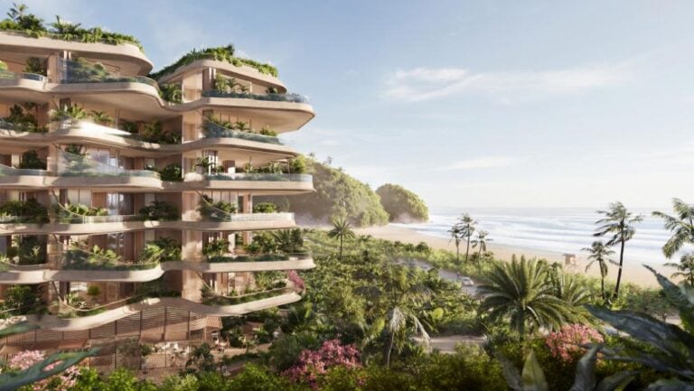 Foster + Partners reveals TEMPO, a luxury oceanfront oasis in Brazil Luxury oceanfront residential building with lush tropical greenery and beach views.