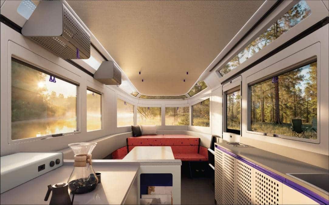 Cozy mobile tiny house interior with large windows and scenic forest views, modern design and compact living space.