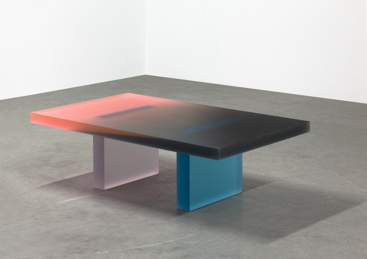 Colorful modern art table by Visual Atelier 8 with vibrant design elements.