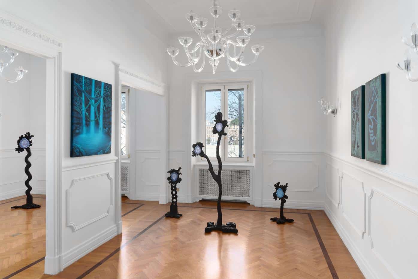 Intricate white walls and modern artwork in a contemporary art gallery space.