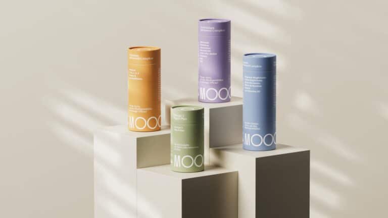 Studio Sentempo crafts Moooor’s premium and sustainable brand identity Vitamins supplement bottles on modern white display stands with soft shadows, highlighting colorful health product packaging.