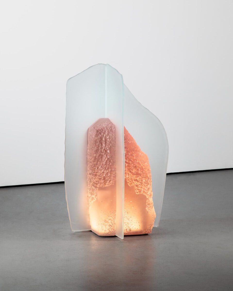 Vase sculpture with textured pink and orange interior, illuminated softly, minimalist art decor.