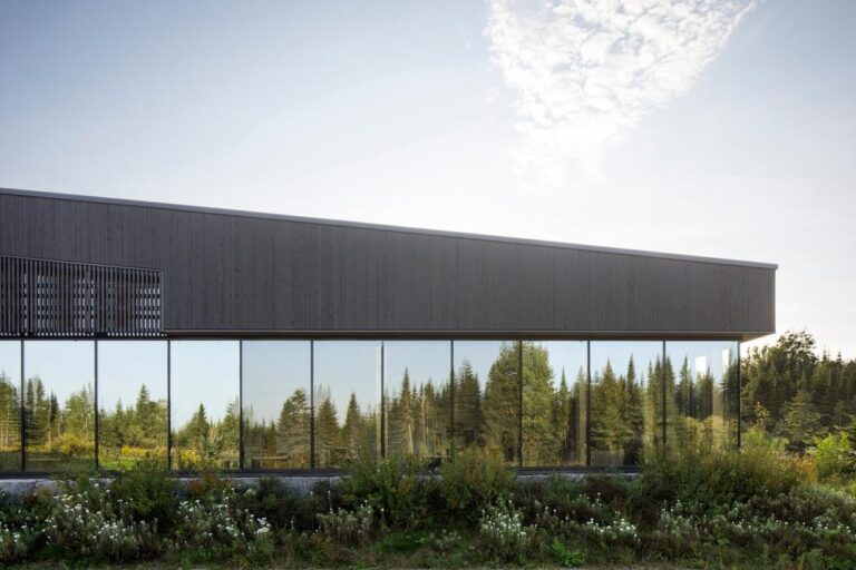 Exterior view of Camp Mercier's new pavilion blending with the Laurentian forest landscape