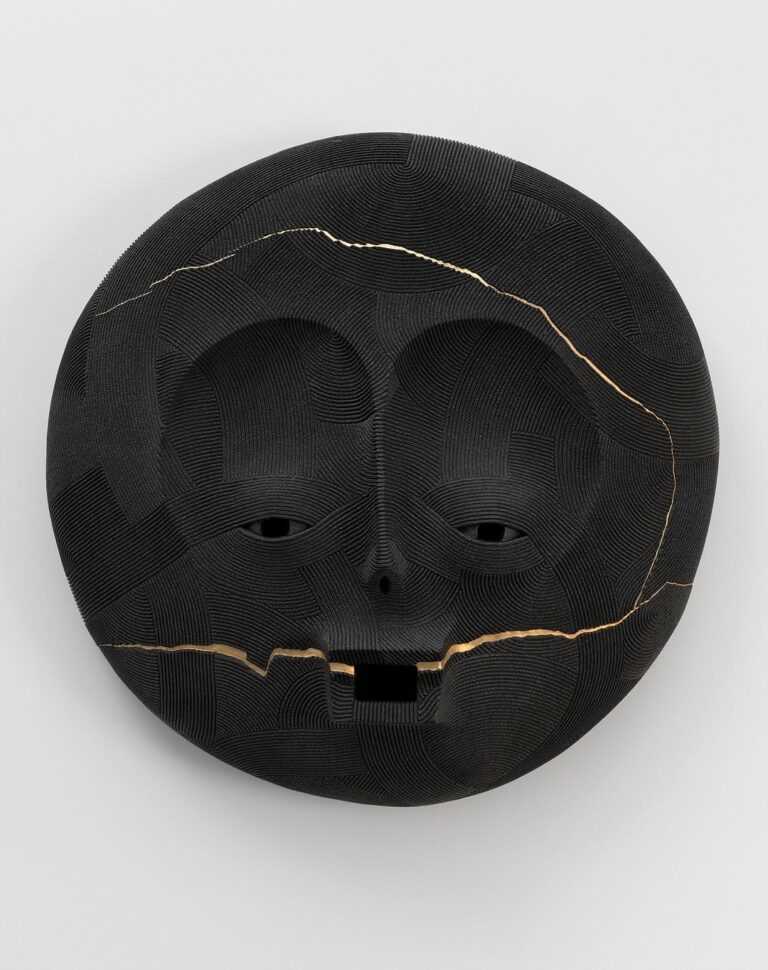 An interview with En Iwamura on the graceful language of ceramics Intricate black mask sculpture with gold accents, expressive face design, and textured surface, suitable for modern art decor.