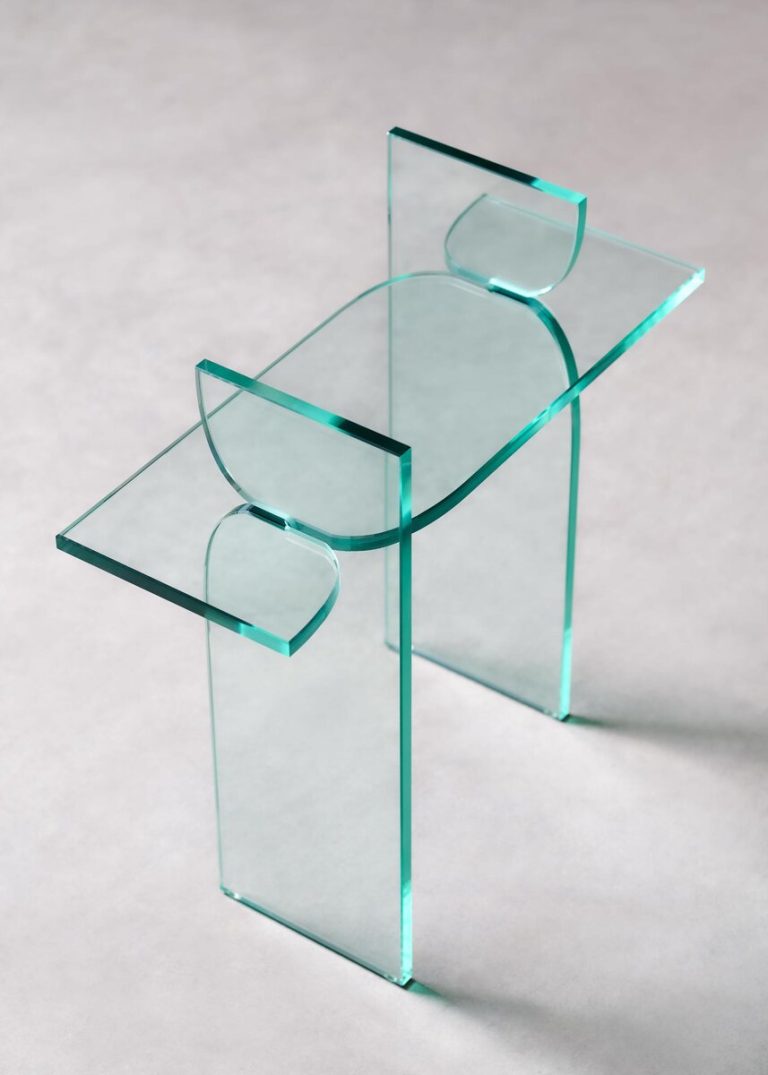 Maria Tyakina’s glass furniture collection redefines transparency and form Translucent glass side table with modern geometric design and sleek craftsmanship.