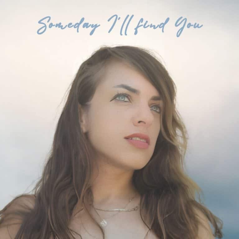 Naama: Someday I’ll Find You (feat. Simon Moullier) Soft-focused portrait of a woman with blue eyes and wavy brown hair outdoors.