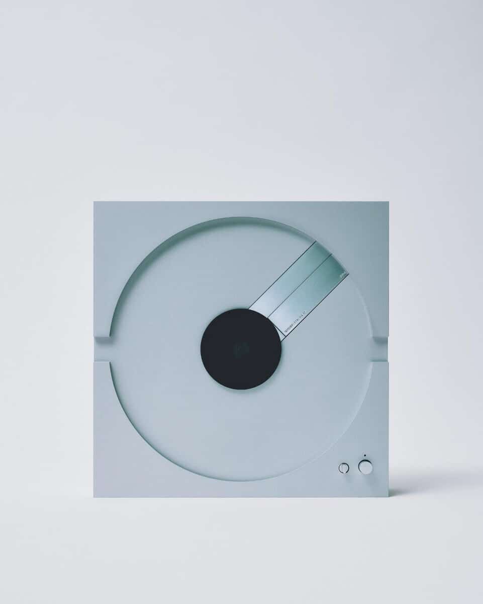 Sliding turntable, minimalist design, modern kitchen appliance, sleek white surface, contemporary style appliance.
