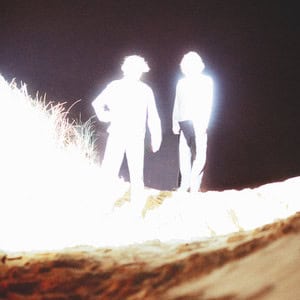 The Flints: The End is the End Brightly illuminated two people standing outdoors at night, high contrast, ethereal lighting, outdoor night scene.