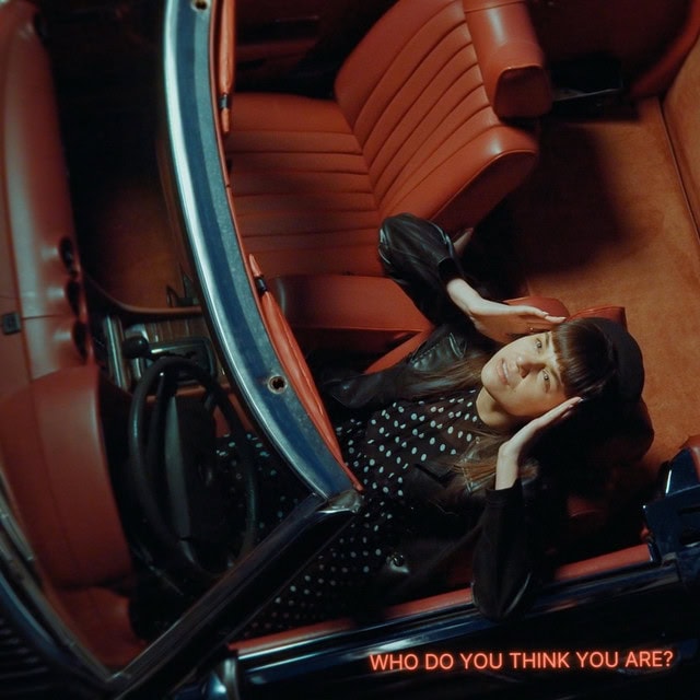 Vintage car interior with woman posing.