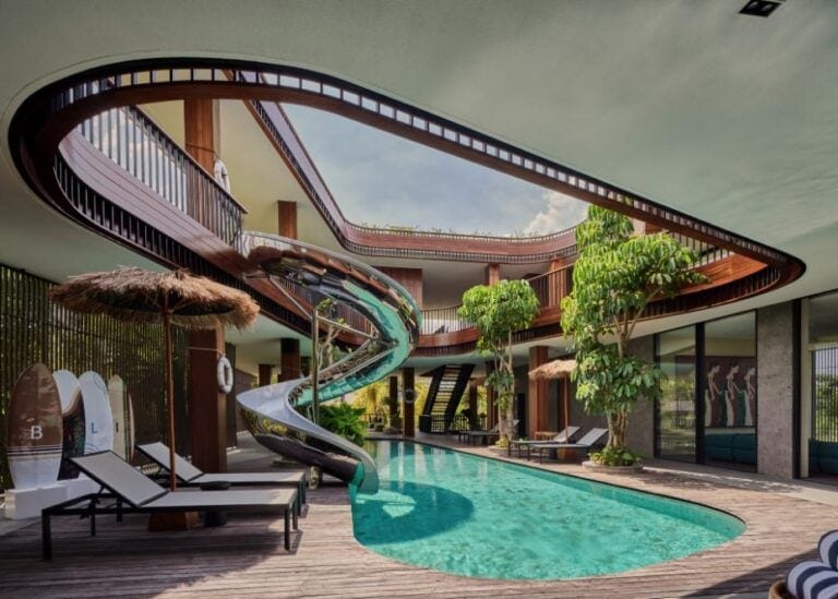 a pool with a slide in the middle of a building