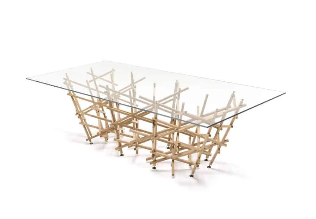 Intricate modern coffee table with wooden lattice base and glass top, showcasing contemporary furniture design.