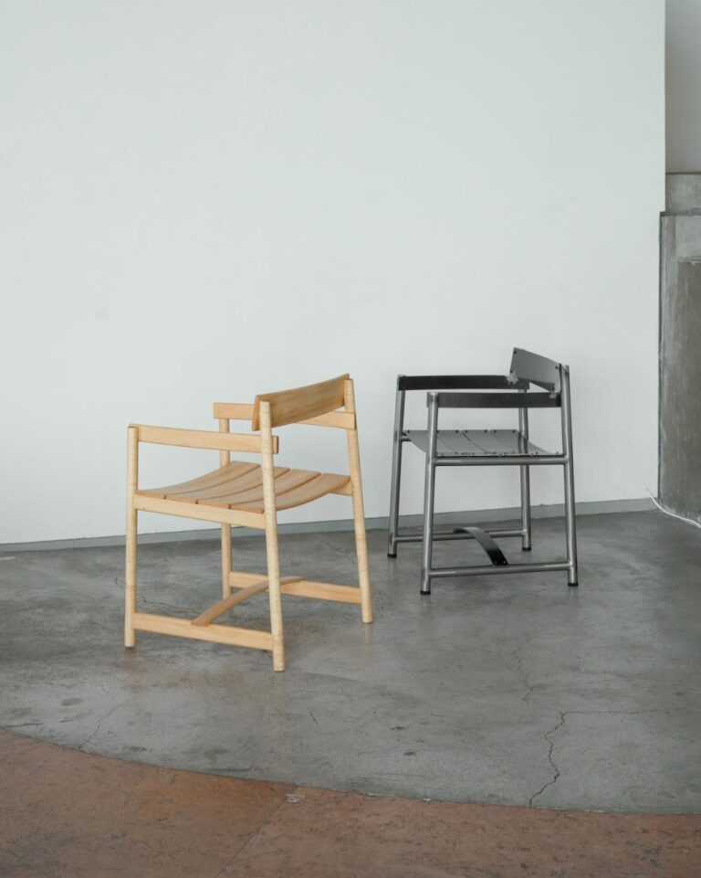 Pedro Arturo transforms culture through poetic industrial design Minimalist modern chairs on a concrete floor in an art gallery or studio setting.
