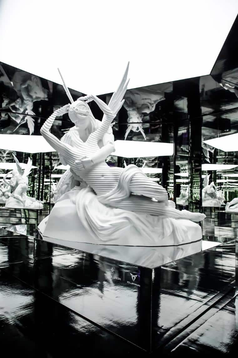 Andrea Crespi’s Future Reflections fuses art and technology to question identity Elegant white fantasy sculpture with futuristic design elements at Visual Atelier 8, modern art installation.