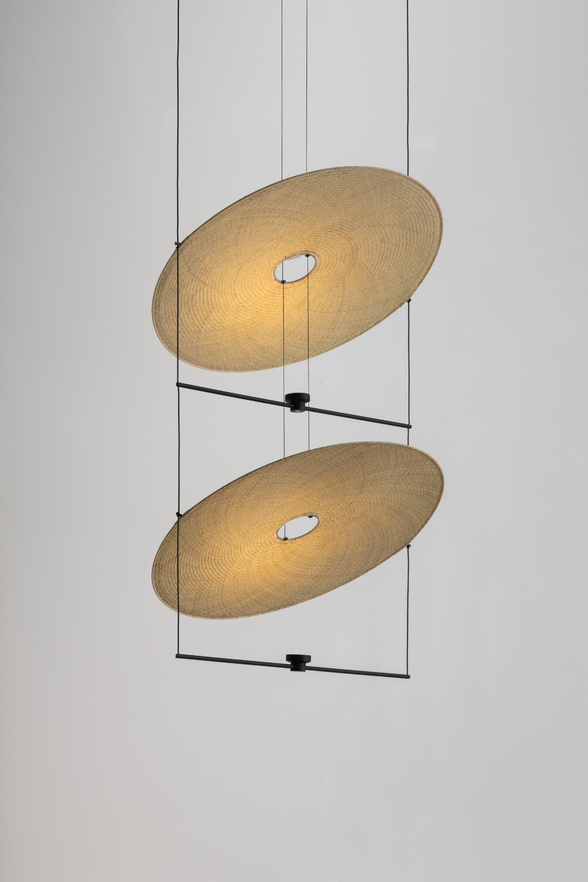 Ceiling pendant light with woven shades and modern black metal design.