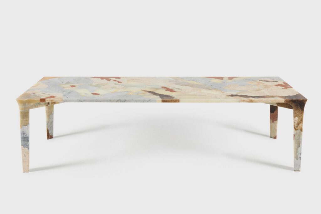 Mapa de Suelos handcrafted stone table featuring layered Peruvian marble and onyx in a sculptural design