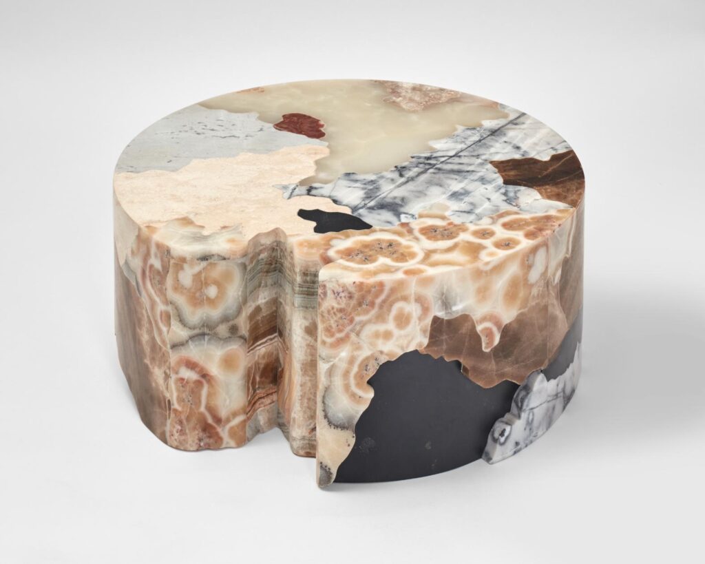 Top-down image of a Mapa de Suelos table showcasing aerial map-inspired stone composition