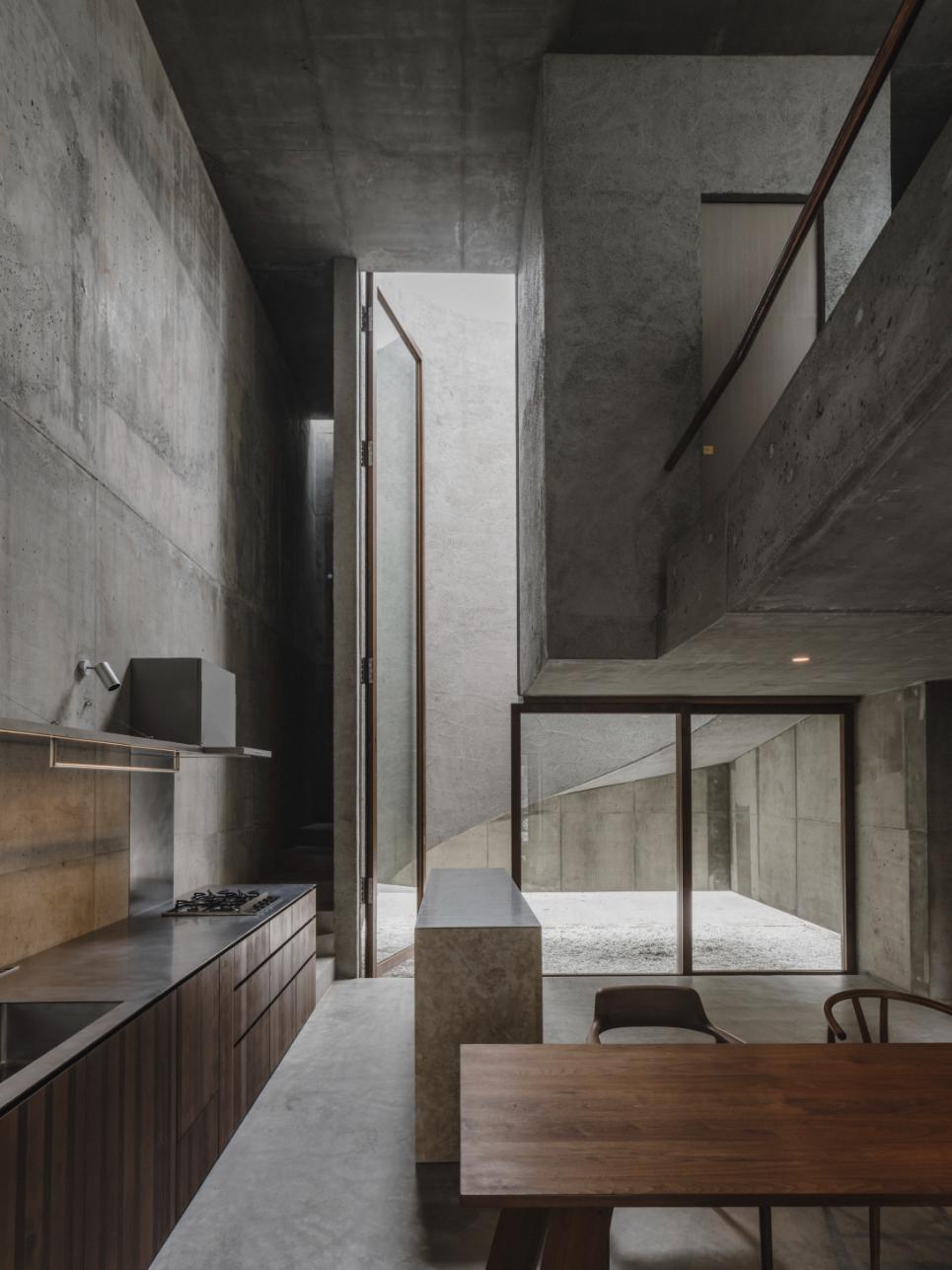 Concrete modern minimalist interior with open layout and large glass windows at Visual Atelier 8, showcasing sleek architectural design.