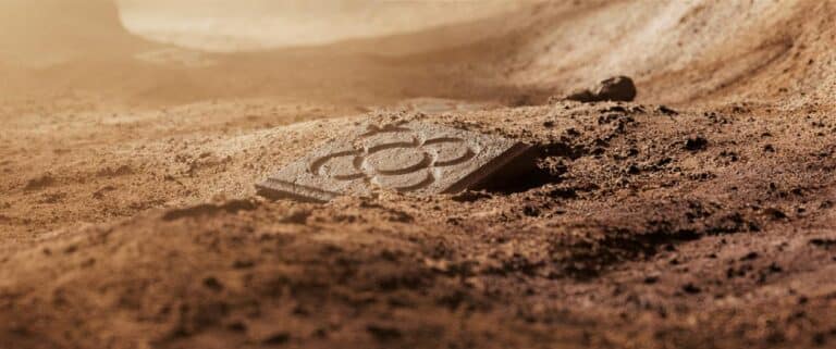 Territory Studio reveals Echoes of Creation for OFFF Barcelona 25th anniversary Rust-colored Martian terrain with a solar panel fragment partially buried in the dust, exploring Mars surface geology and space exploration technology.
