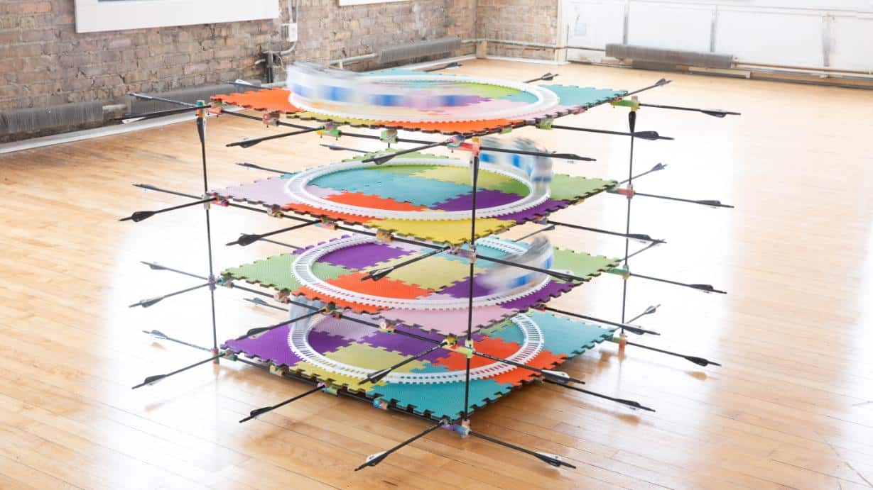 Colorful drone racing track with multiple circular racing circuits on foam mats Indoor sports facility.