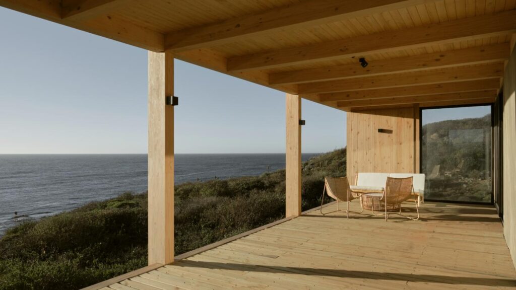 Panoramic view from the balcony at sunset, capturing the Pacific Ocean horizon and sky from CR House