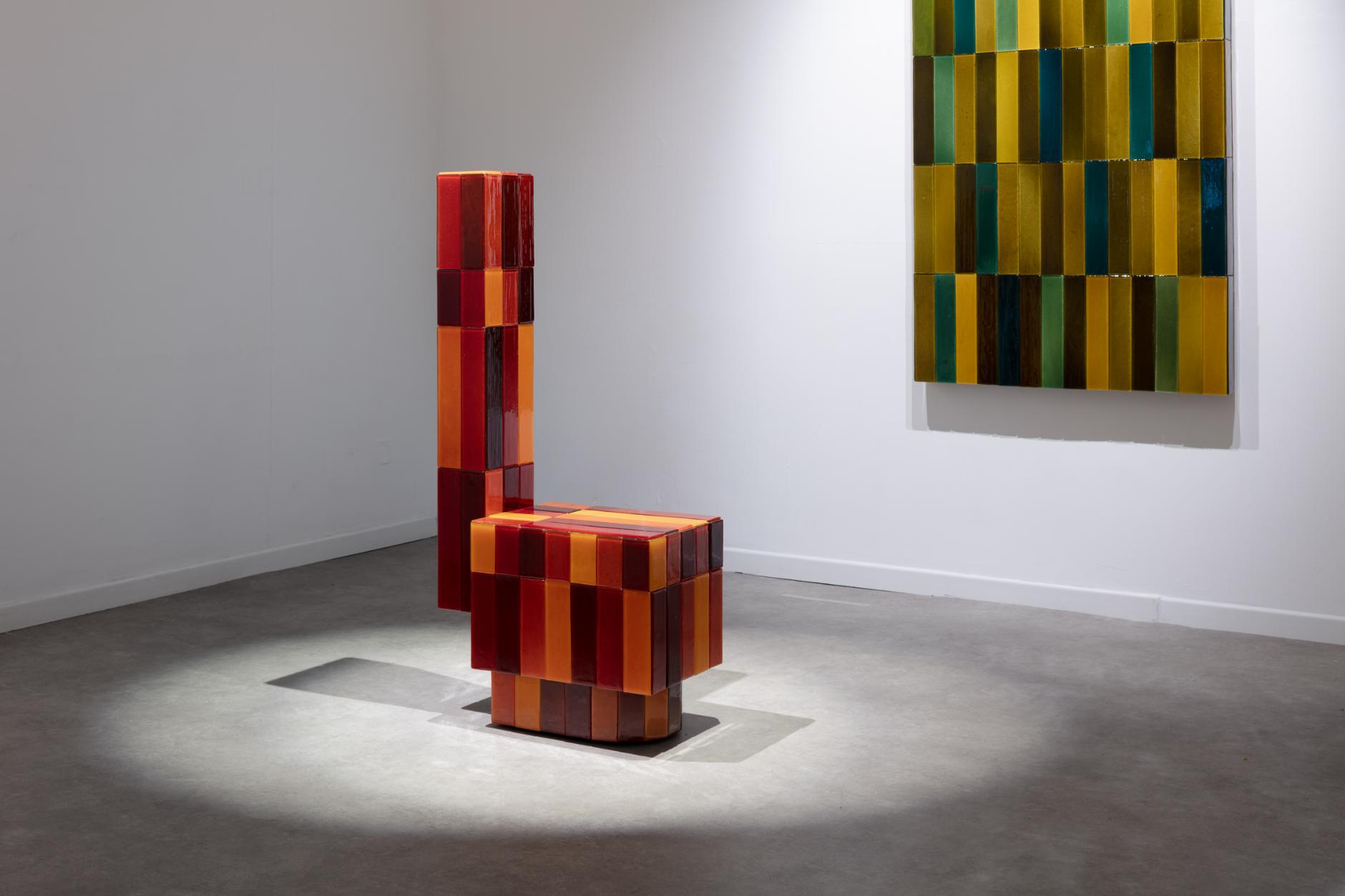 Colorful geometric furniture sculpture in contemporary art gallery.