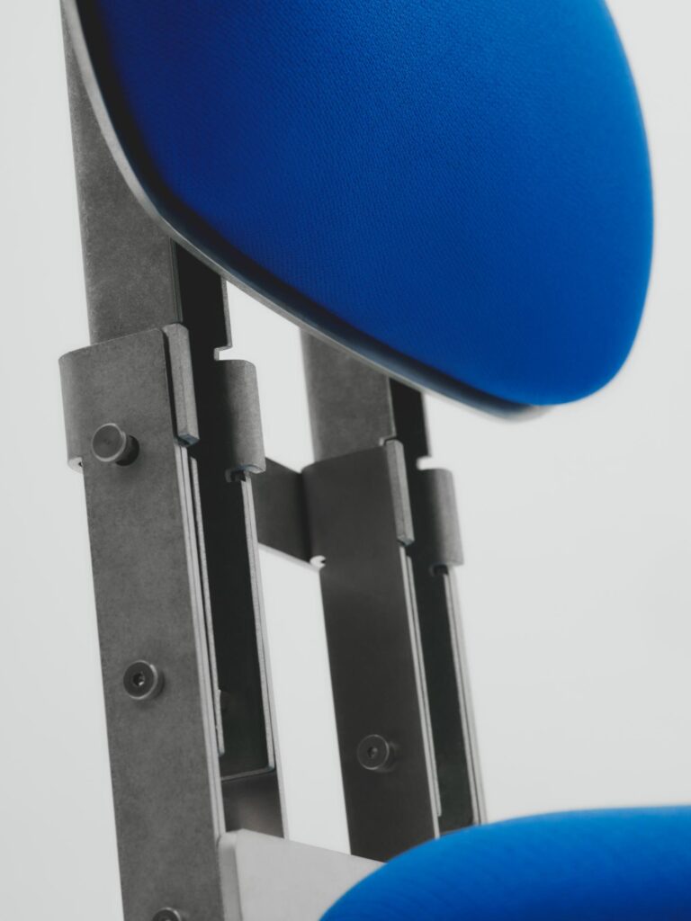 Side view of modular aluminum chair with visible screws and silicone legs for anti-slip support