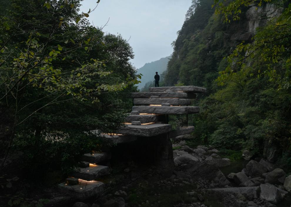 Suspended stone roof over forest hut at Drifting Stones by DoDesign