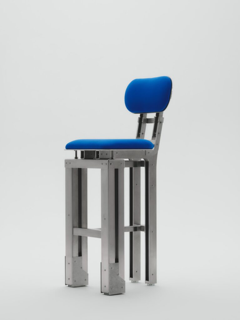 Custom industrial-style chair made from laser-cut aluminum with upholstered seat and backrest