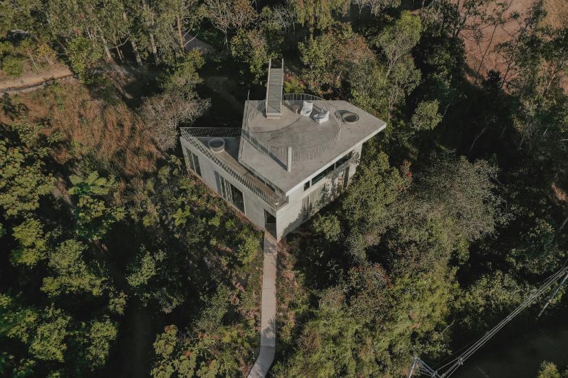 Exterior view of triangular concrete house by Atelier García on a hilltop in Guatapé