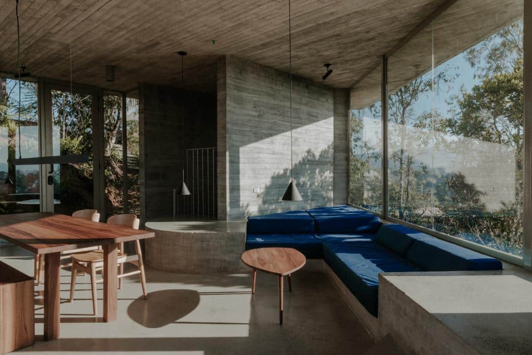 Modern minimalist interior with large glass windows and concrete accents at Visual Atelier 8.