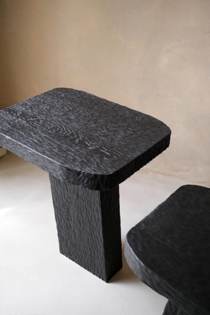 Hand-carved Youtopia side table in charred European oak with flowing organic texture