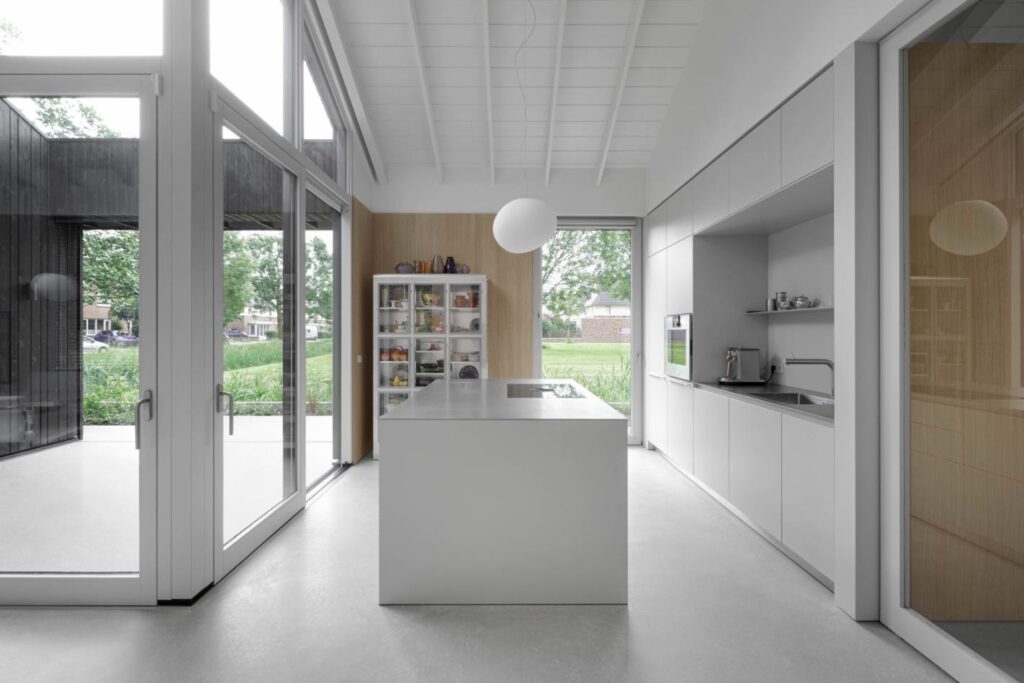 Open living area connected to central patio in i29 multigenerational house