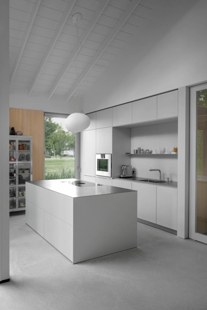 Custom kitchen cabinetry integrated with oak wall cladding in senior home