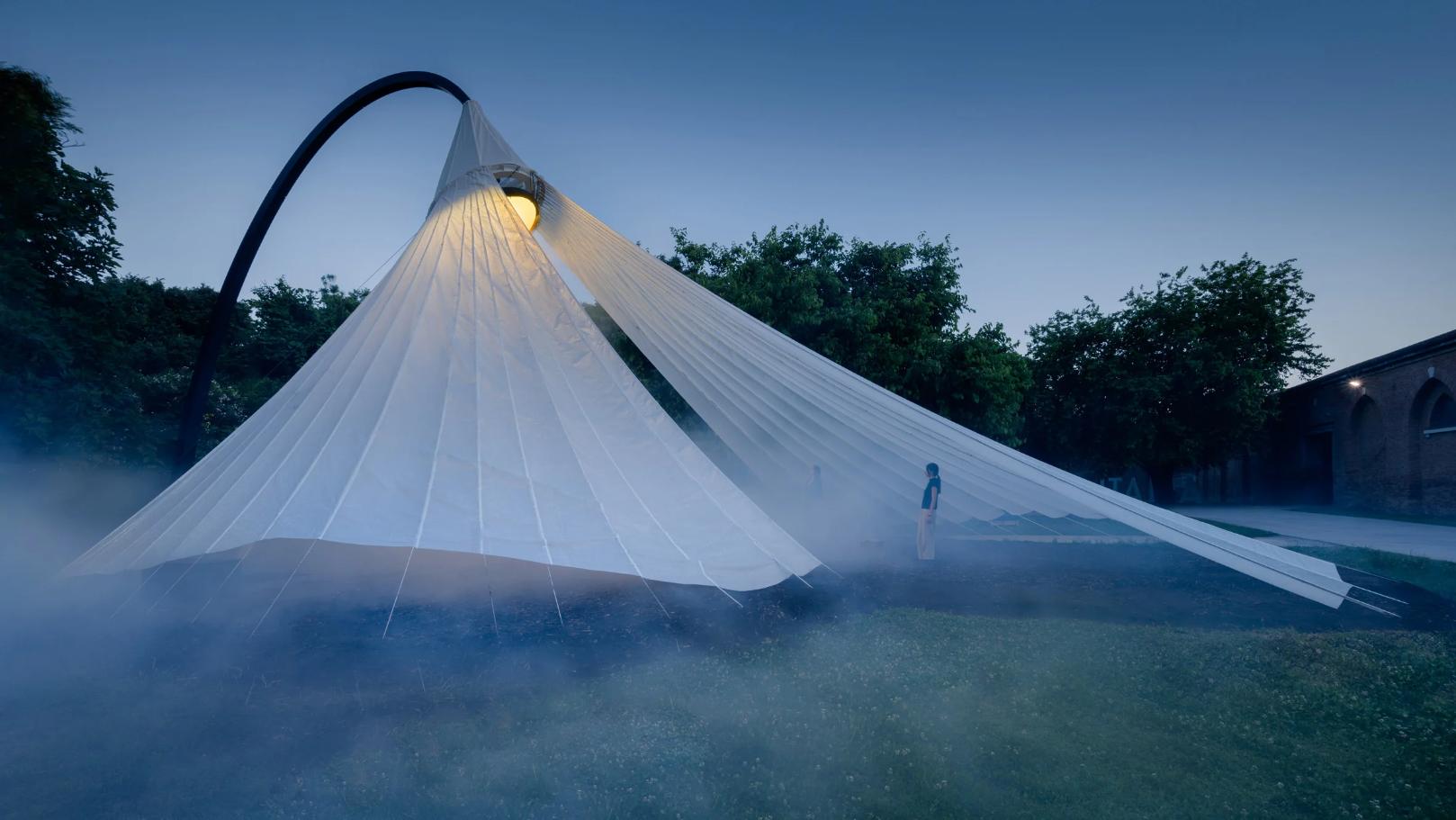 Futuristic outdoor art installation featuring a large, illuminated fabric canopy by Visual Atelier 8.