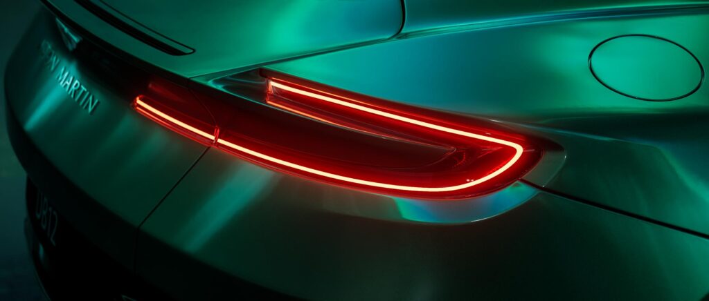 Detailed side view of Aston Martin in CGI night landscape with reflective lighting