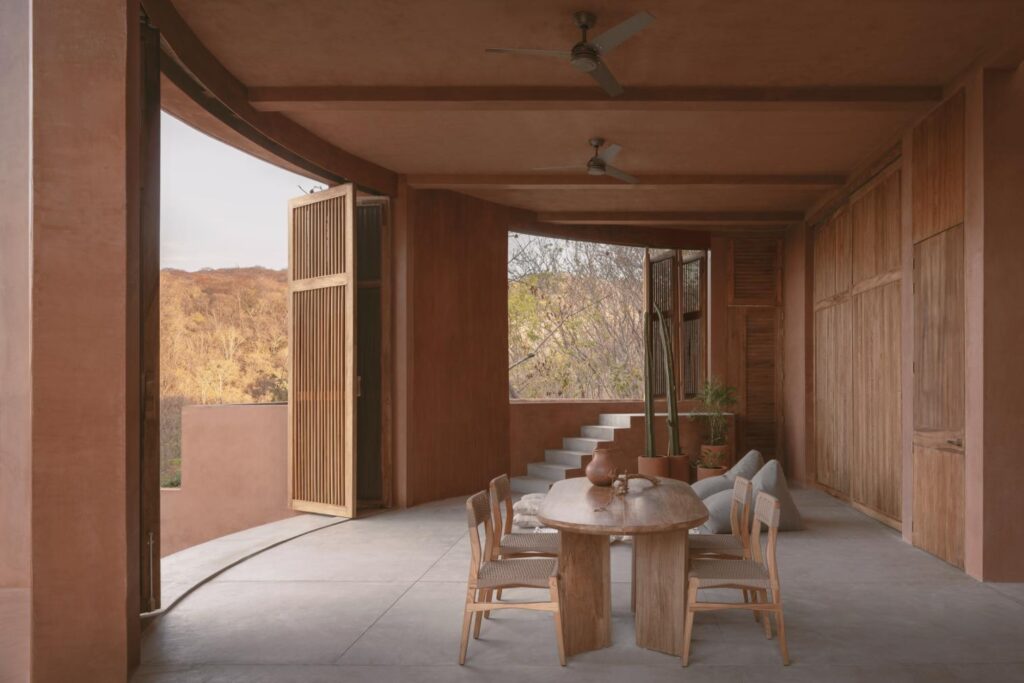 Textured earth-toned walls of Casa Tobi blending with the arid landscape of Puerto Escondido