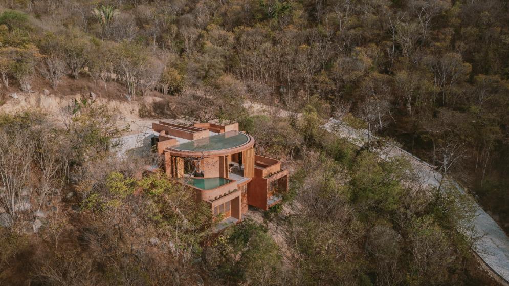 Aerial view of Casa Tobi on the Oaxacan coast showcasing its stepped design and integration with the natural slope