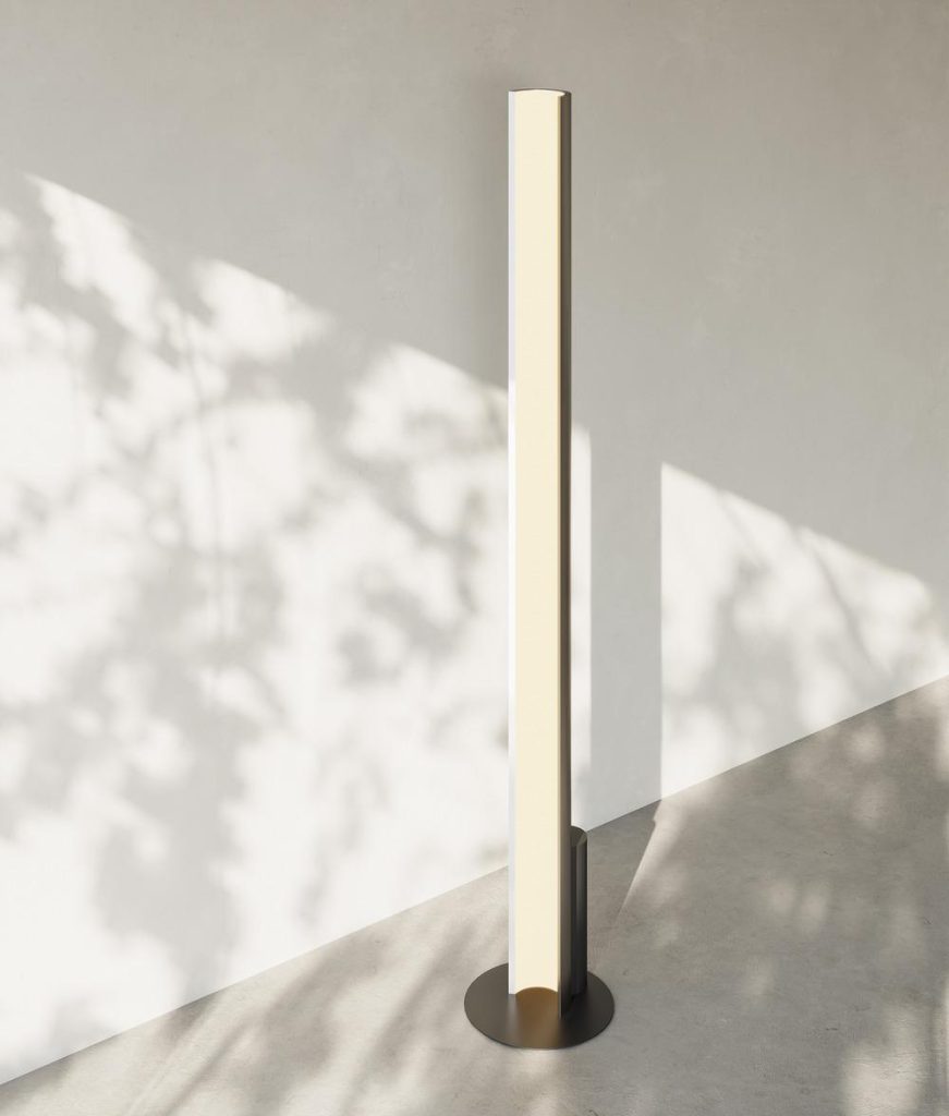 Pola floor lamp in champagne finish illuminating corner of contemporary interior
